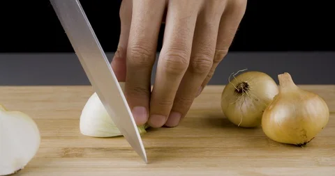 Chef hands are cutting an onion Stockbeeldmateriaal 94334779