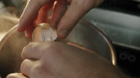 Chef hands break an egg into boiling water in a pot in slow motion 스톡 동영상 150762365