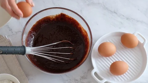 Chef hands breaking egg. Egg break in slow motion. Making homemade chocolate Stock Footage 121109799