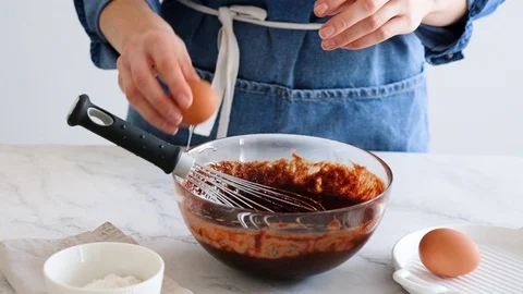 Chef hands breaking egg. Egg break in slow motion. Making homemade chocolate Stock Footage 121110005