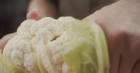 Chef hands breaks fresh cauliflower in slow motion. 4K video Stock Footage 123001040