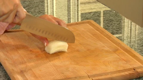Chef hands chop up crispy white onion on cutting board Stock Footage 123732656