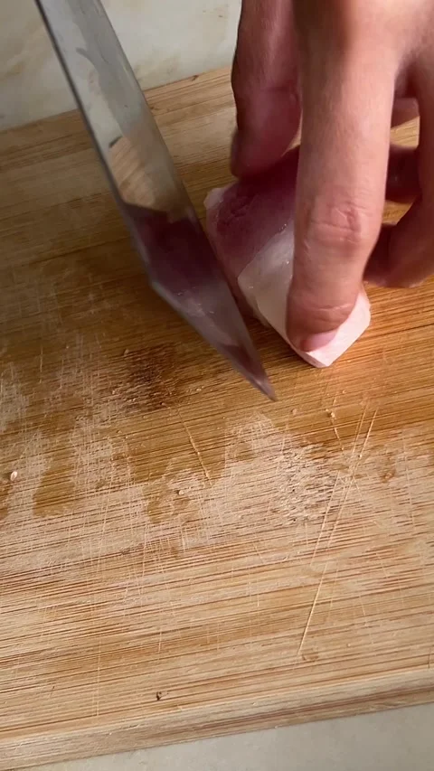 Chef hands chop fat meat with a big knife or axe on a cutting board. Ground meat Stock Footage 284339989