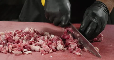 Chef hands chopping the meat with a knife. Close-up Stock Footage 259338103