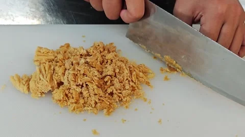 Chef hands chopping palm sugar on a white cutting board. Stock Footage 342737359