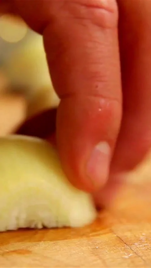 Chef hands chopping white onion on wooden board Stock Footage 334169171