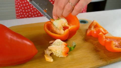 Chef hands cooking cutting red bell pepper removing core with seeds on kitchen. Stock Footage 312399521