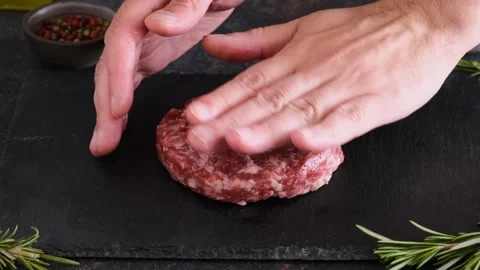 Chef hands cooking raw meat burger on black slate board Stock Footage 196612792