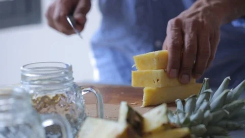 Chef hands cut pineapple on wooden cutting board. Man preparing fruit dessert 스톡 동영상 88951042
