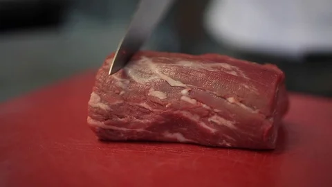 Chef Hands Cut Raw Steak Meat On A Cutting Board Stock Footage