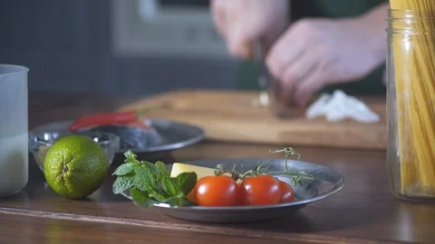 Chef hands cuts onions in restaurant kitchen on wooden cutting board. 스톡 동영상 124708912
