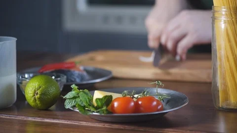 Chef hands cuts onions in restaurant kitchen on wooden cutting board. Stock-Footage 124708931