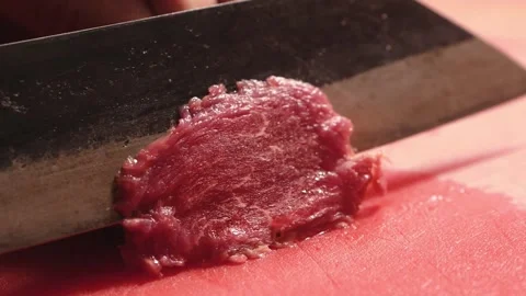 Chef hands cutting carpaccio raw beef meat into thin slices Stock Footage 203912678