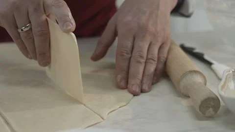 Chef Hands Cutting Dough with Kitchen Utensil Stock Footage 165497726