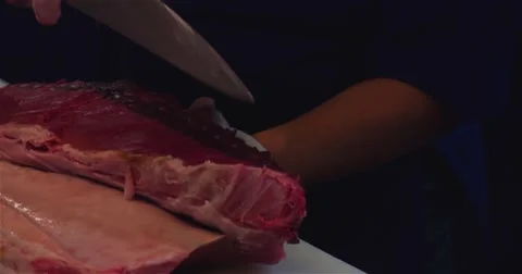 Chef hands cutting with knife big tuna fish 4k close up video restaurant kitchen Stock Footage 67487650