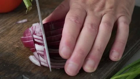 Chef hands cutting red onion with knife on wooden board. Cooking vegetarian Stock Footage 251014970