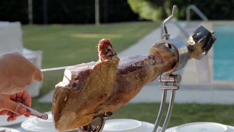Chef Hands Cutting Spanish Ham on Summer Day Stock Footage 110478904