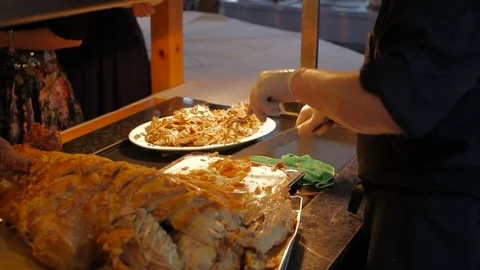 Chef Hands cutting whole grilled pig knife on cutting board Stock Footage 75845989
