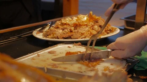 Chef Hands cutting whole grilled pig knife on cutting board Stock Footage 75846236