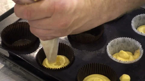 Chef hands fill dough for baking muffins. Stock Footage 99170471