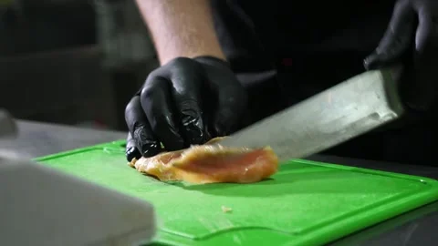 Chef hands in gloves cutting red fish on small pieces in a restaurant kitchen Stock-Footage 135255956