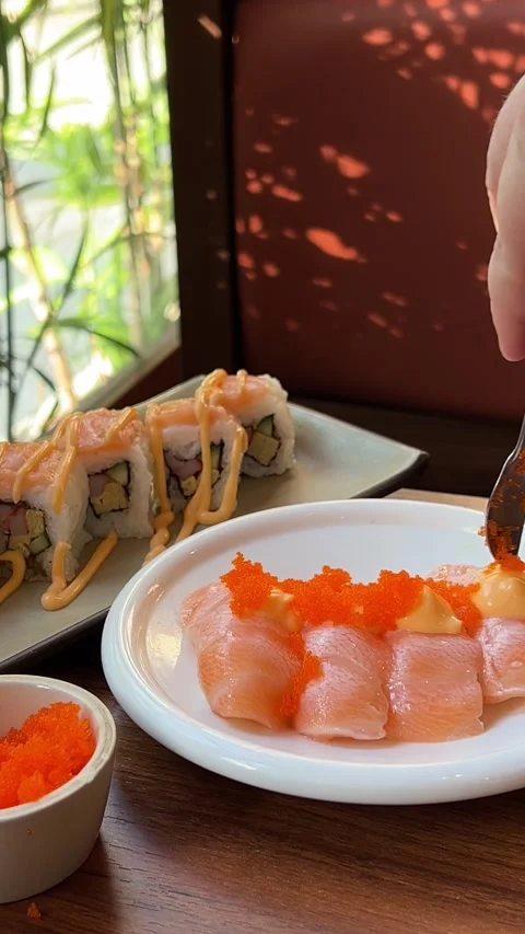 Chef hands in gloves pit red caviar on fish. lrrl traditional asian cuisine Stock Footage 317698464