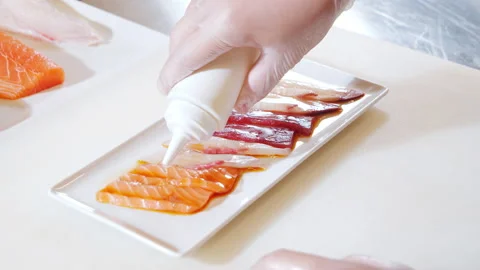 Chef hands in gloves preparing delicious appetizer of fish with truffle sauce Stock Footage 142144278