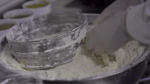 Chef hands in gloves preparing flour for breading in professional kitchen 스톡 동영상 332114589