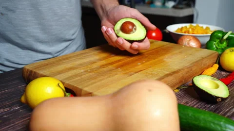 Chef hands in home kitchen removing the pit of an avocado with a knife. Stock Footage 302304001