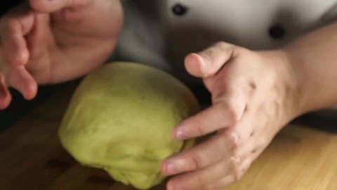 Chef Hands Kneading Matcha Dough on Wooden Board Stock Footage 201284246