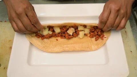 Chef hands making enchiladas Stock Footage 229900131