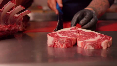 Chef hands making a heart shape form raw fresh beef meat ribeye. Video stock 295259913