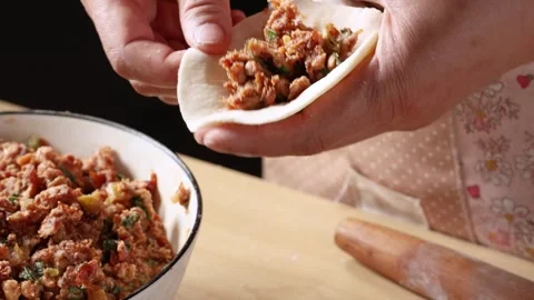 Chef Hands Making Traditional Chinese Dumplings with Meat Filling Close Up Stock Footage 339561570