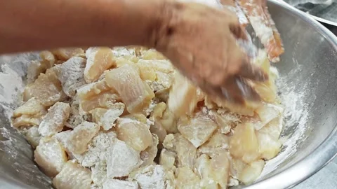 Chef hands mixing raw fish pieces with flour in a bowl. Stock Footage 342516995