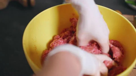 Chef hands mixing raw mince meat seasoned with salt, pepper and paprika spice Stock Footage 223486892