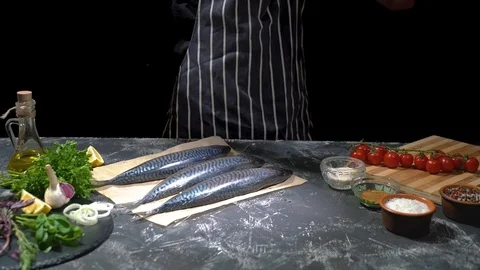 Chef hands prepare raw fish, sprinkling salt with the ingredients Stock Footage 118349479