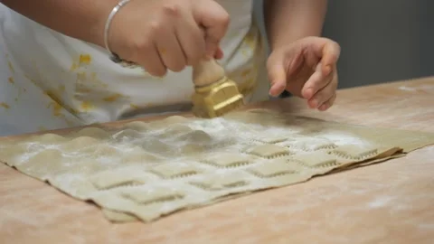 Chef hands preparing fresh pasta, separating tortelli and ravioli parcels from Stock Footage 318223177