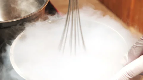 Chef hands preparing ice cream from berries and fruits using a liquid nitrogen Stock Footage 137450880