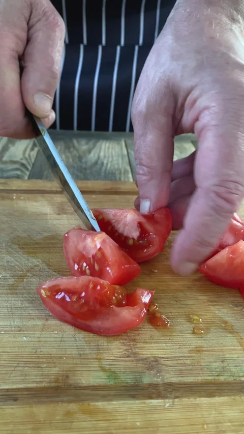 Chef hands preparing raw tomato slices for meal Cutting vegetables for cooking. Stock Footage 341108437