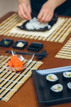 Chef hands preparing sushi Stock Photos