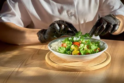 Chef hands preparing vegetable salad. copy space Stock Photos