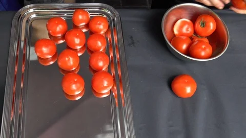 Chef hands put ripe tomatoes vegetables into steel dish. Handheld shot. Stock-Footage 115690416