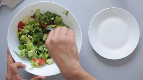 Chef hands put the salad in a bowl Stock Footage 88950946