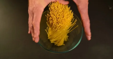 Chef hands put Spaghetti in Bowl Top view Advertising shot 4K video Stock Footage 104061316
