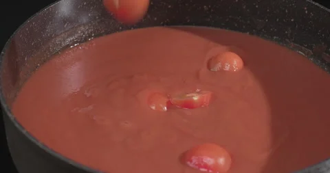 Chef hands put tomatoes into Italian tomato sauce for making pasta Stock Footage 249987952