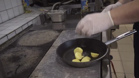 Chef hands puts boiled potatoes in a pan, to fry Stock Footage 121793547