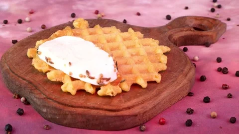 Chef hands putting slice of mozzarella, tomato and parsley over liege waffles Stock Footage 194506856