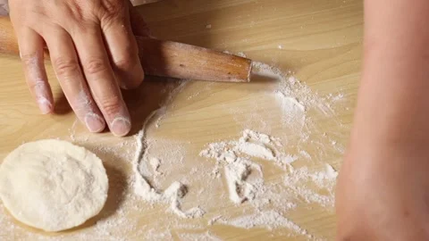 Chef Hands Rolling Out Fresh Dough with Wooden Pin in Macro Slow Motion Stock Footage 339560577