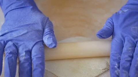 Chef hands rolling out pasta disc for homemade ravioli pasta Stock Footage 128698899