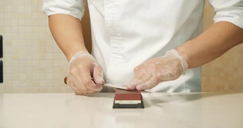 Chef hands sharpening knife. Closeup man hands preparing professional tools Stock Footage 135498933